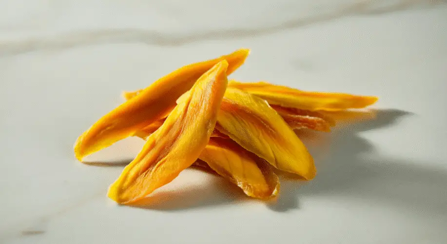 Dried mango snacks on a white background.