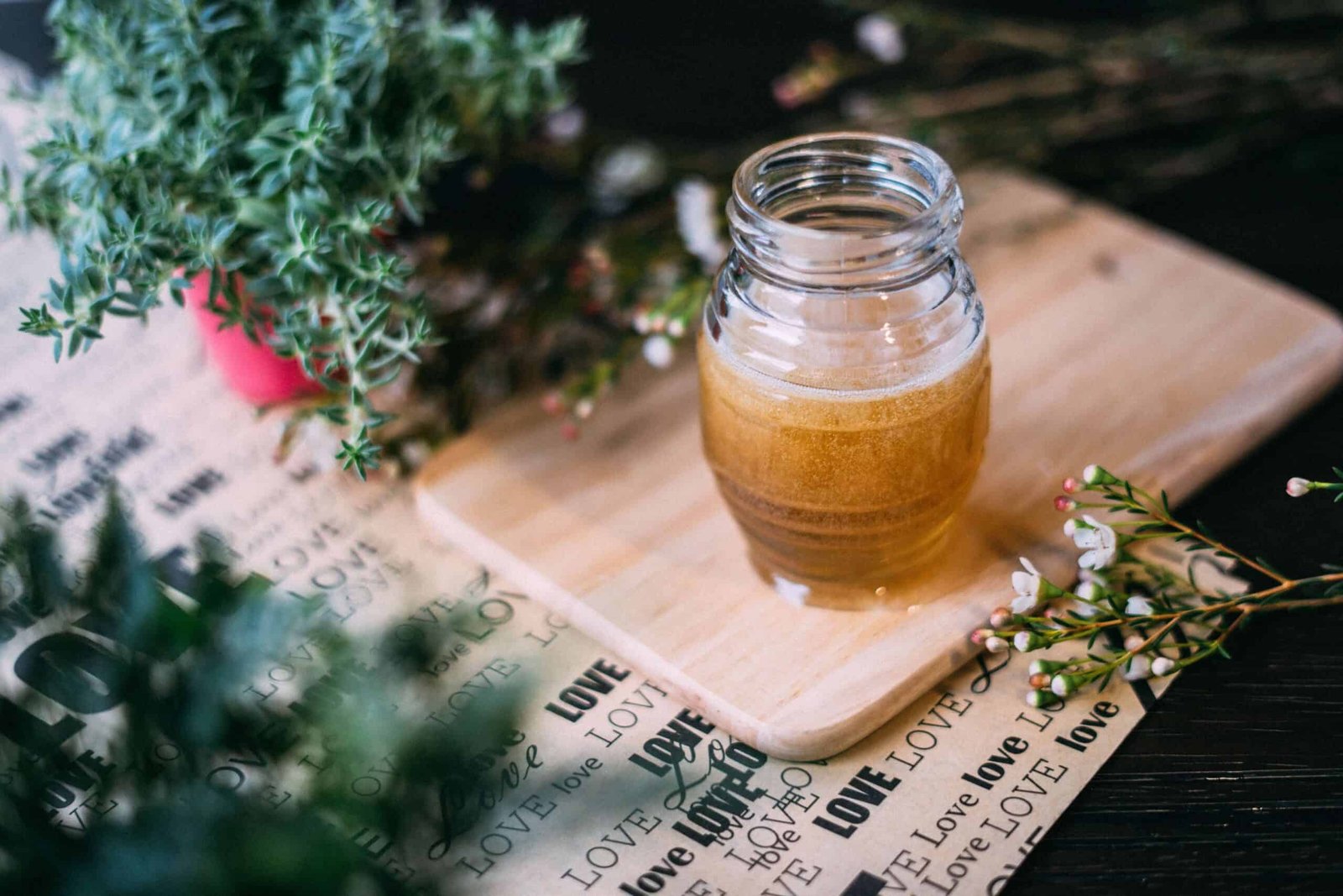 honey in a jar on a wooden board