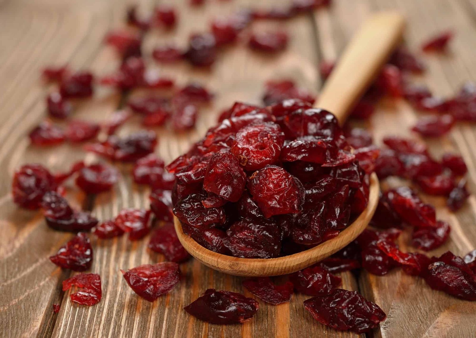 Dried cranberries on brown background