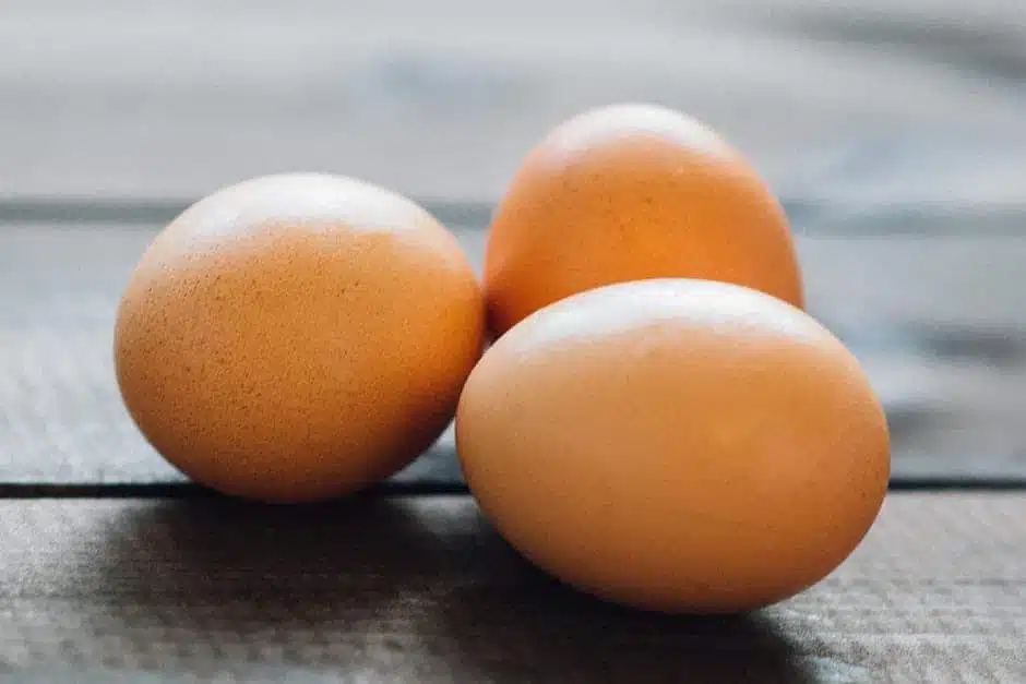 three eggs on wooden background