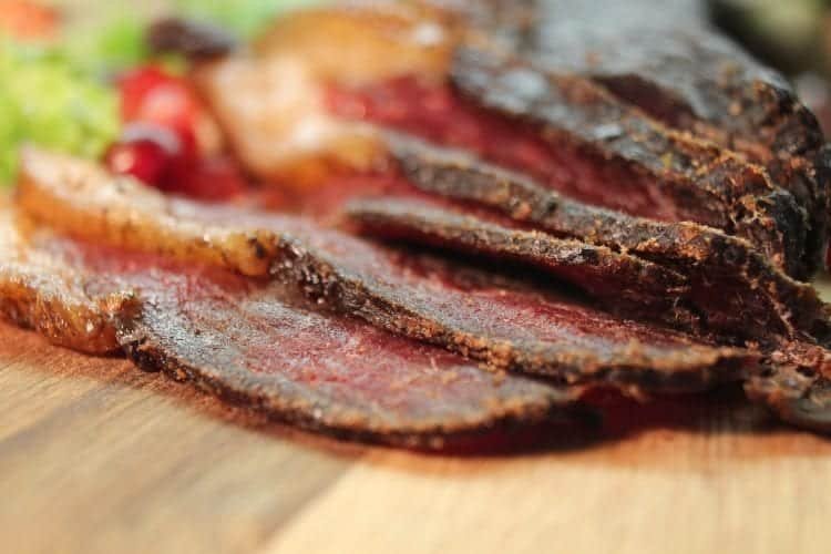 sliced jerky on wooden table