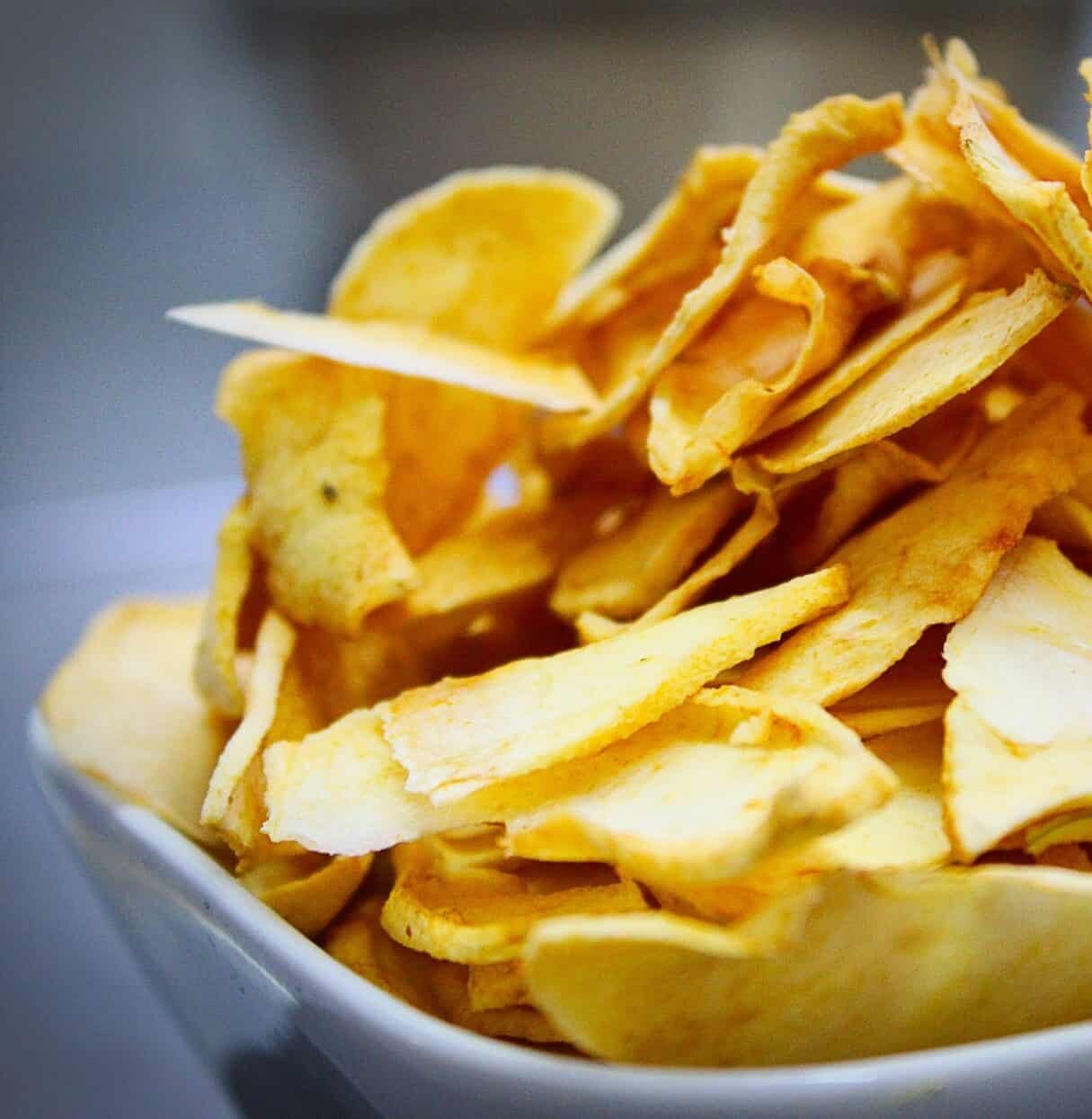 apple chips stacked in glass plate
