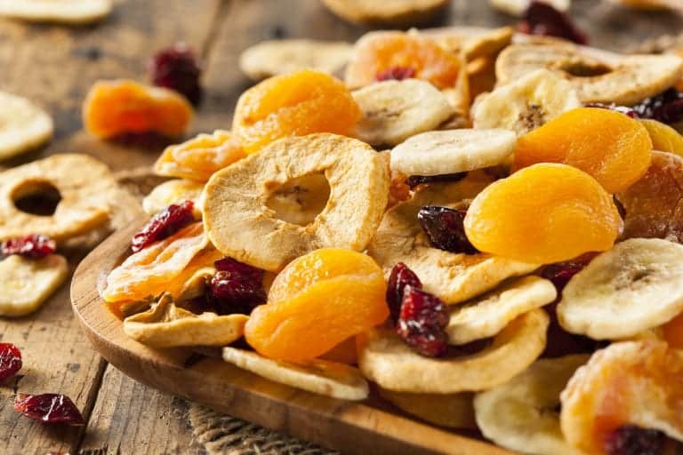 dehydrated fruits in wooden bowl on a wooden table