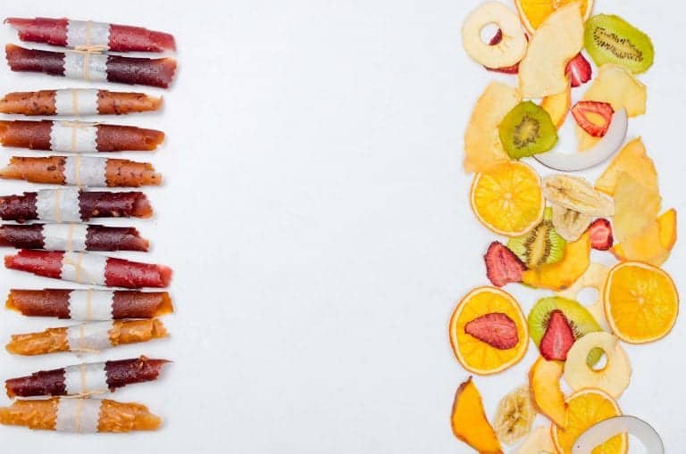 fruit leather, slices of oranges, strawberries, apples, kiwis with white background