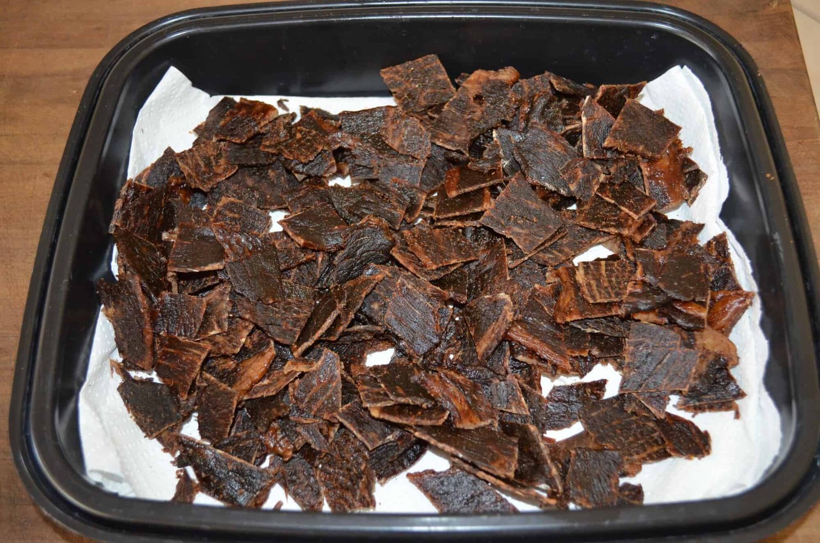Sliced dehydrated jerky on parchment paper