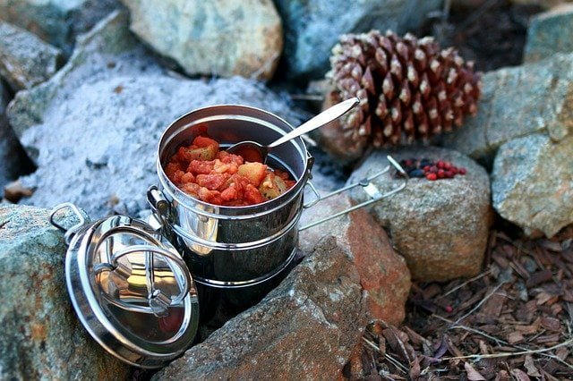 food in metal container with spoon