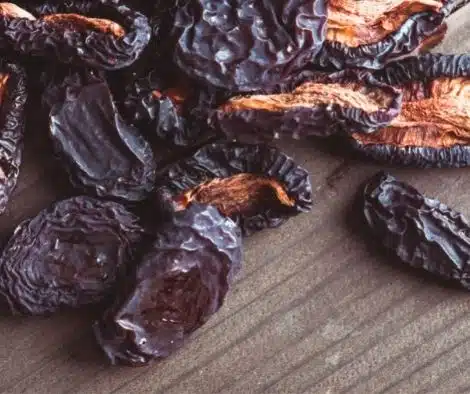 dehydrated plums on wooden table