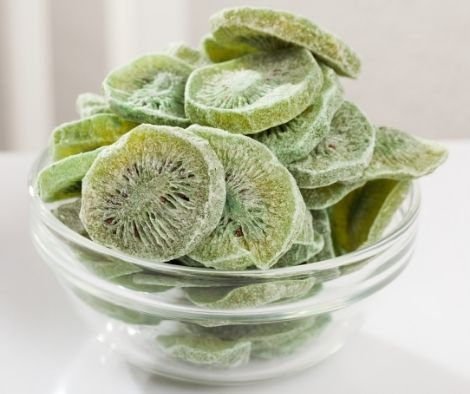 Natural dehydrated kiwi slices without sweeteners or preservatives in bowl. Healthy vitamin snack