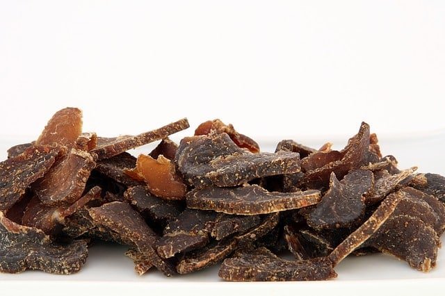 sliced dehydrated beef jerky on white backdrop