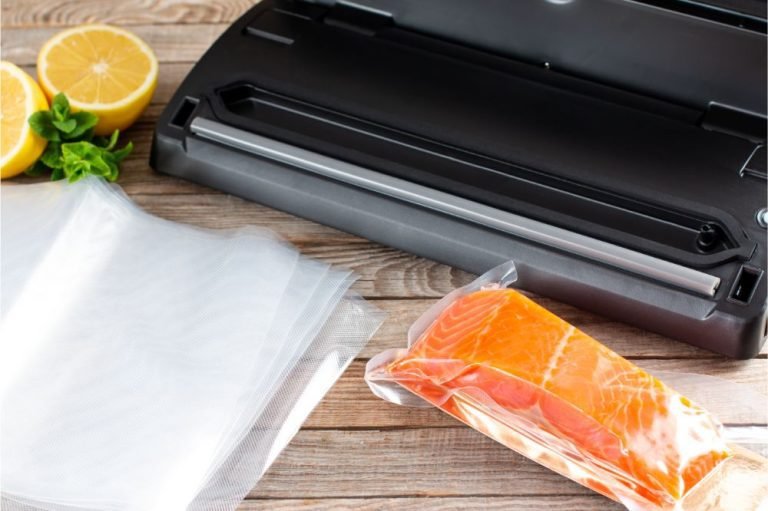 vacuum sealer machine on wooden table with vacuum salmon packed