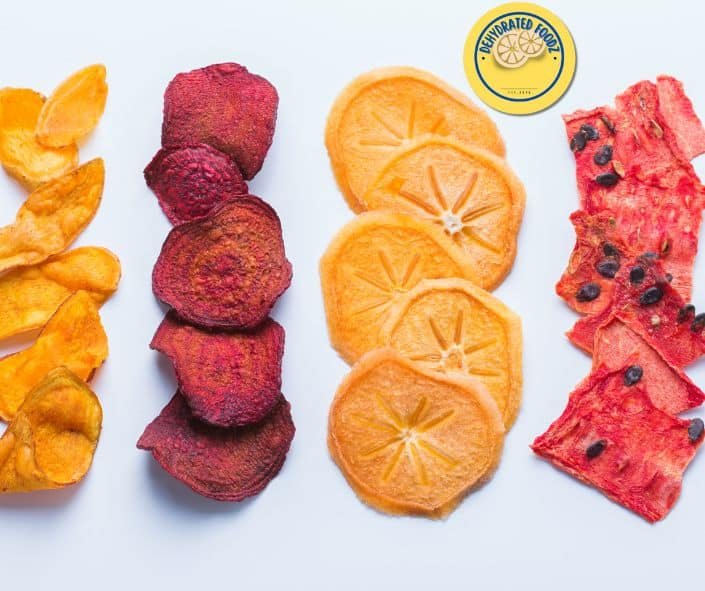a line of dehydrated watermelon, orange, beetroot and peach on a white background.