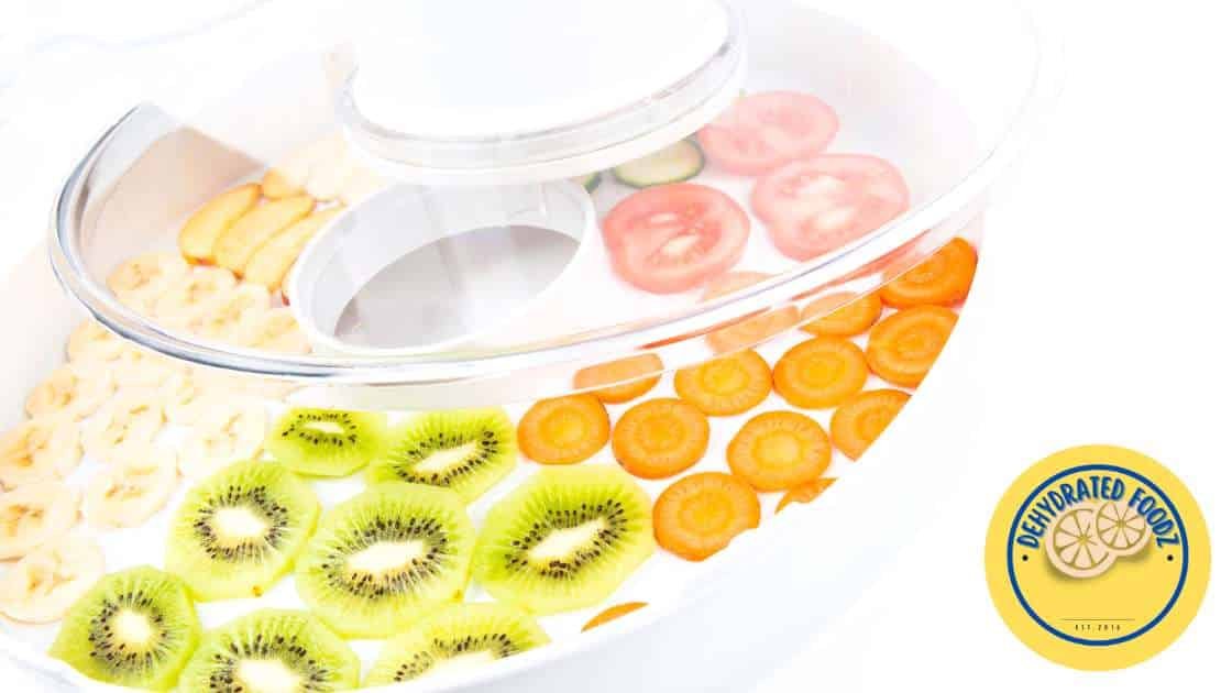 sliced fruit and vegetables ready to be dehydrated on dehydrator trays