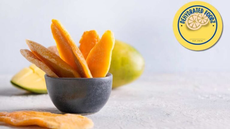 dehydrated mango slices in a bowl on a grey background
