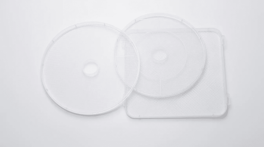 The image features a set of dehydrator replacement trays, designed to fit various dehydrators for drying fruits, vegetables, herbs, and meats. These reusable trays are clean and displayed neatly, showcasing their durability and functionality as essential accessories for food preservation.