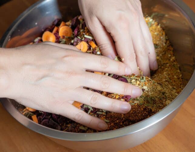 A persons hand blending the soup mix.