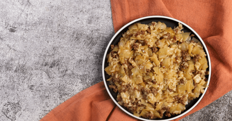 rice, onions meat in a bowl on a marble background