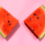 sliced watermelon fruit on a pink background