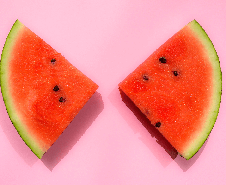 sliced watermelon fruit on a pink background
