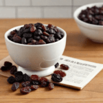raisins in a white bowl on a wooden table