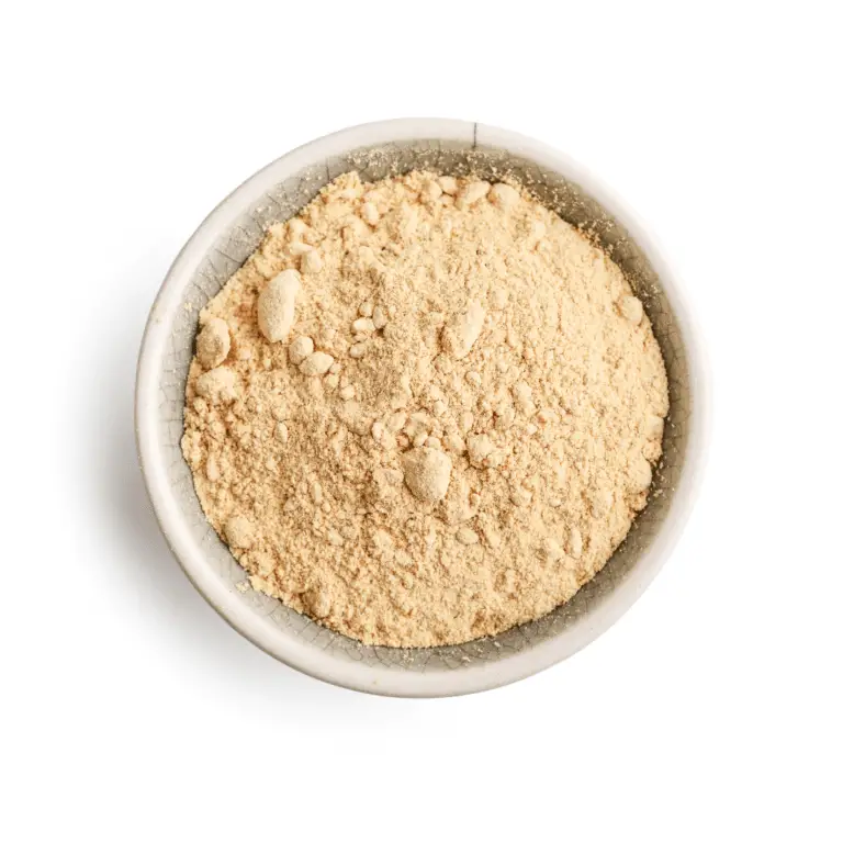 dried ginger powder in a bowl on a white background.