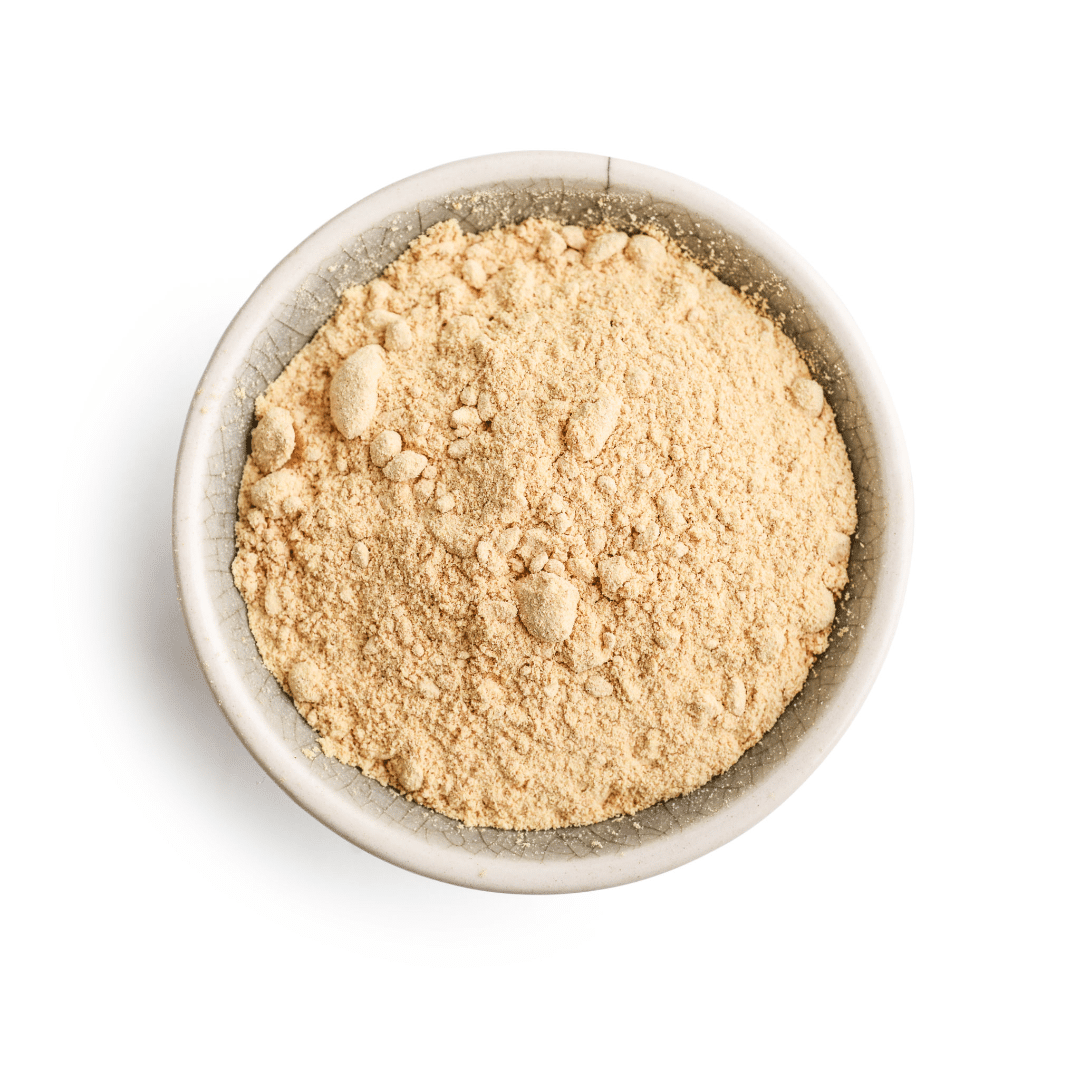 dried ginger powder in a bowl on a white background.