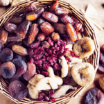 Dried fruits in a basket on a grey background