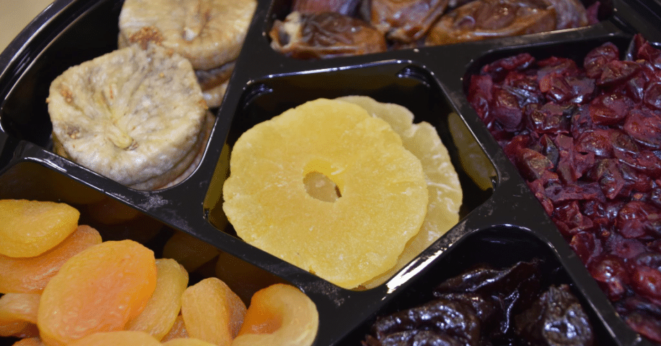 dried plums, figs, pineapple rings in a platter