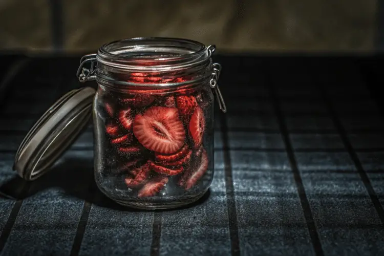 dried strawberry chips in a mason jar