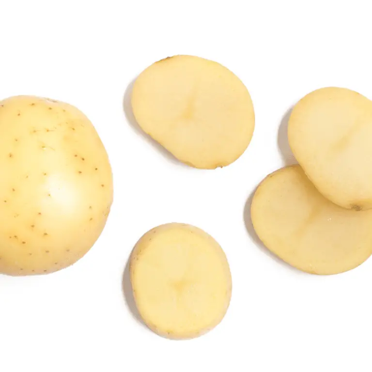 whole and sliced potato on a white background.