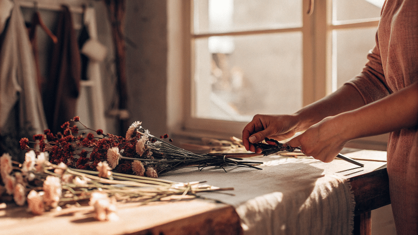 A woman preparing flowers to be dried.
