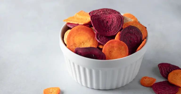 dehydrated beetroots, beets in a ceramic bowl on a light grey background.