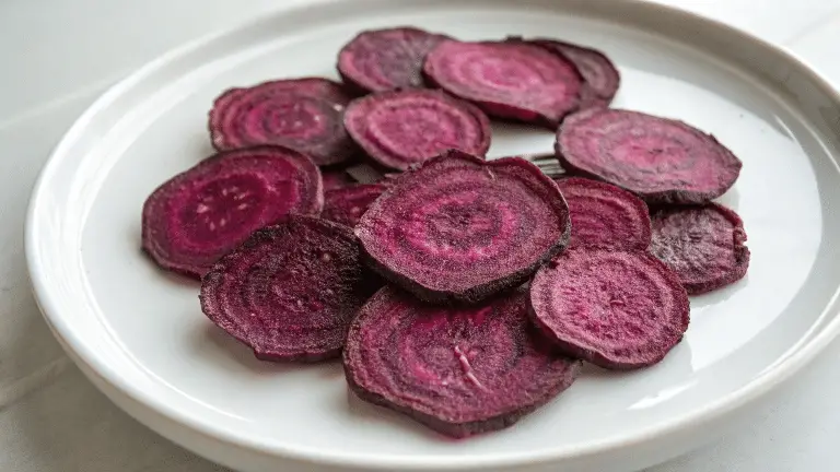 Beet chips in a white ceramic plate.