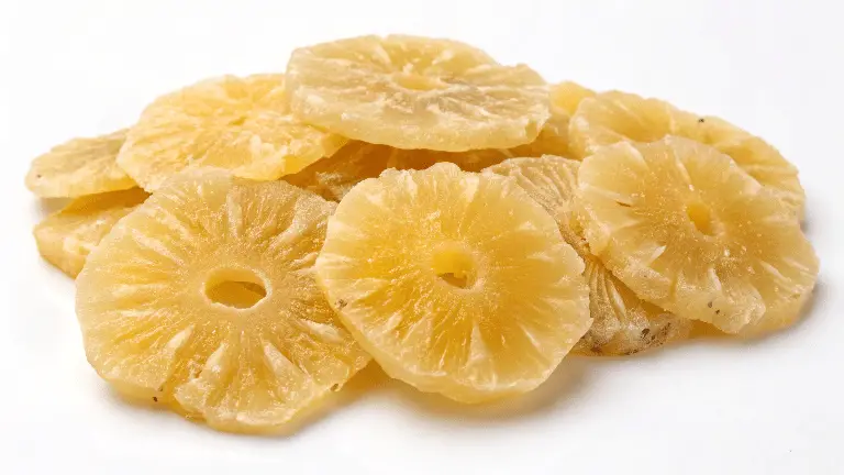 Dehydrated pineapple chews on a white background.