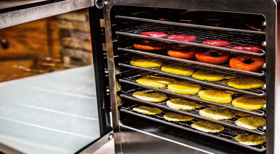 Food dehydrator lined with food on trays.