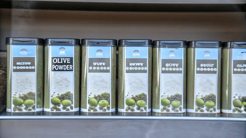 A photo of a shelf with a series of containers for olive powder.