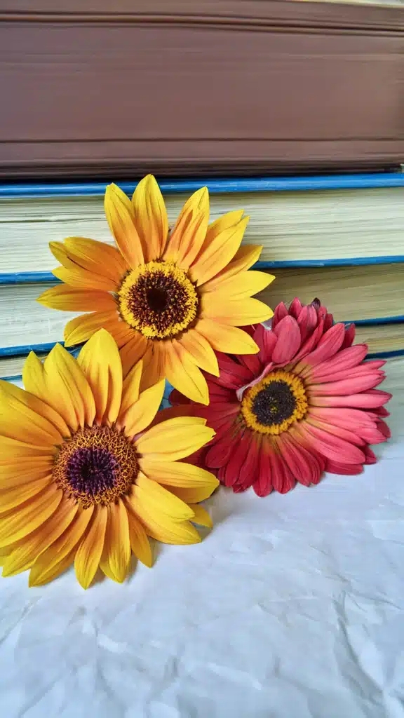 flowers between parchment paper and a heavy book.