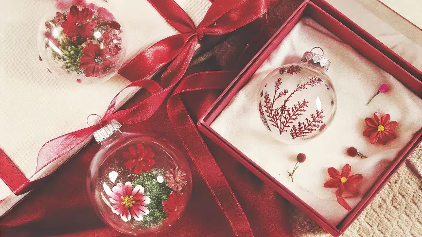 Glass circular ornament with dried flowers.