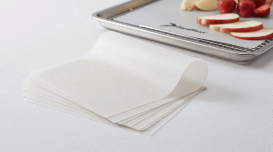 The image features a set of Paraflexx premium sheets designed for use with an Excalibur dehydrator, showcasing their non-stick surface ideal for making fruit roll-ups and leathers. The durable, brown sheets are easy to clean and perfect for dehydrating various food items, ensuring a hassle-free process for customers.