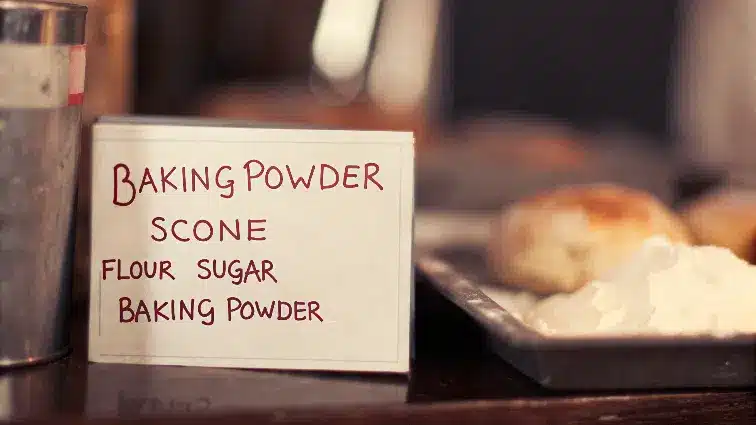 Baking powder next to a sign saying baking powder scone, flour sugar.